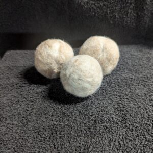 Three balls of soap sitting on top of a towel.