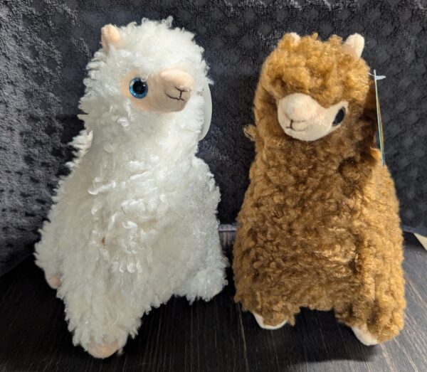 Two stuffed animals one is white and the other brown