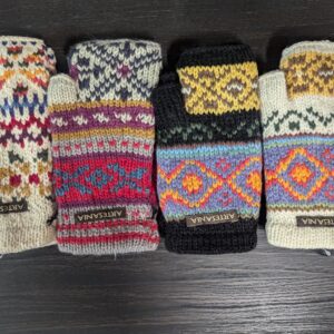 A group of four different colored mittens sitting on top of a table.