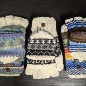 Three pairs of gloves are lined up on a table.